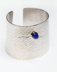 Reptilia Maxima silver cuff with blue chalcedony cabochon set in 18k gold, angled front view.