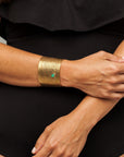 Model wearing the Reptilia Maxima vermeil cuff with green, on-wrist.