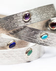 Natural gemstone cabochon detail on the Reptilia Mini silver bracelet.