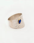 Three-quarter view showing the sculptural band of the Reptilia silver ring.