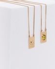 Grace scapular necklace by Carlota Guardia Jewelry from the Be Grateful collection, designed to support a daily gratitude ritual, crafted in recycled gold with natural peridot gemstone.