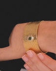 Reptilia Cuff by Carlota Guardia in vermeil and sterling silver worn by a model, showcasing the different sizes and finishes of the design